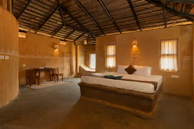 Rustic wooden double bed and earthy decor in the mud house wayanad rooms