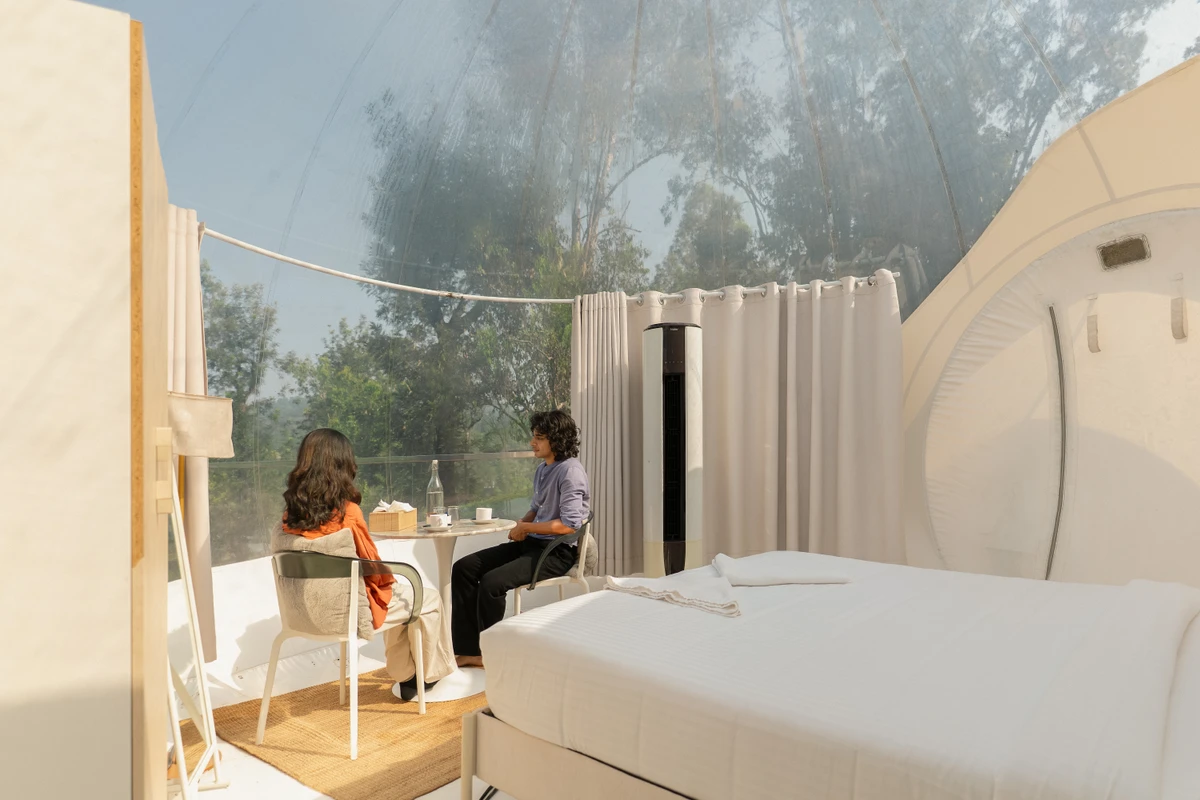 Climate-Controlled Bubble Dome Suite Luxury climate-controlled bedroom setup inside transparent bubble dome wayanad